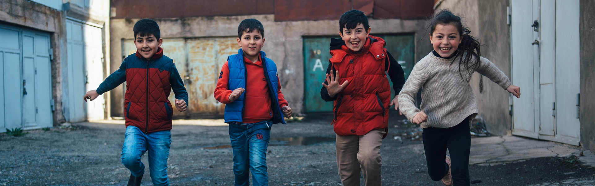 Children running in backstreet near Sevan Baptist Church.