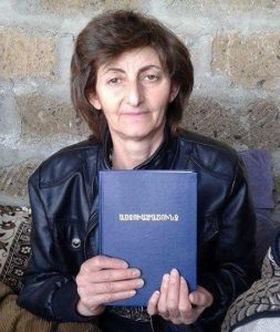 Armenia woman holding a blue book