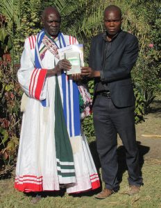 Feston standing with a leader both holding the same book