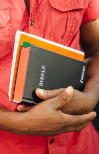 Mãos de um homem segurando uma Bíblia