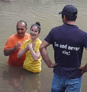 Yester being baptized in a river
