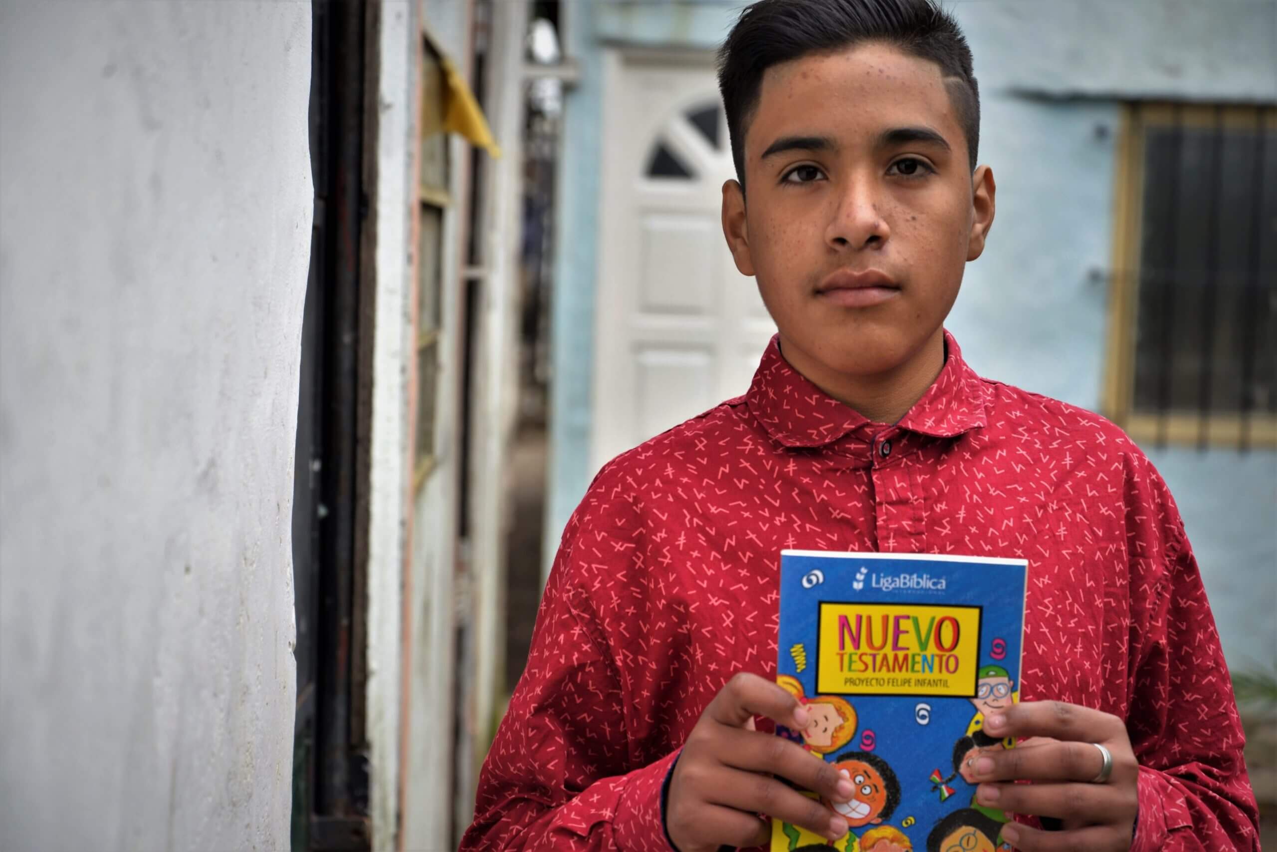 Isaias holding a book