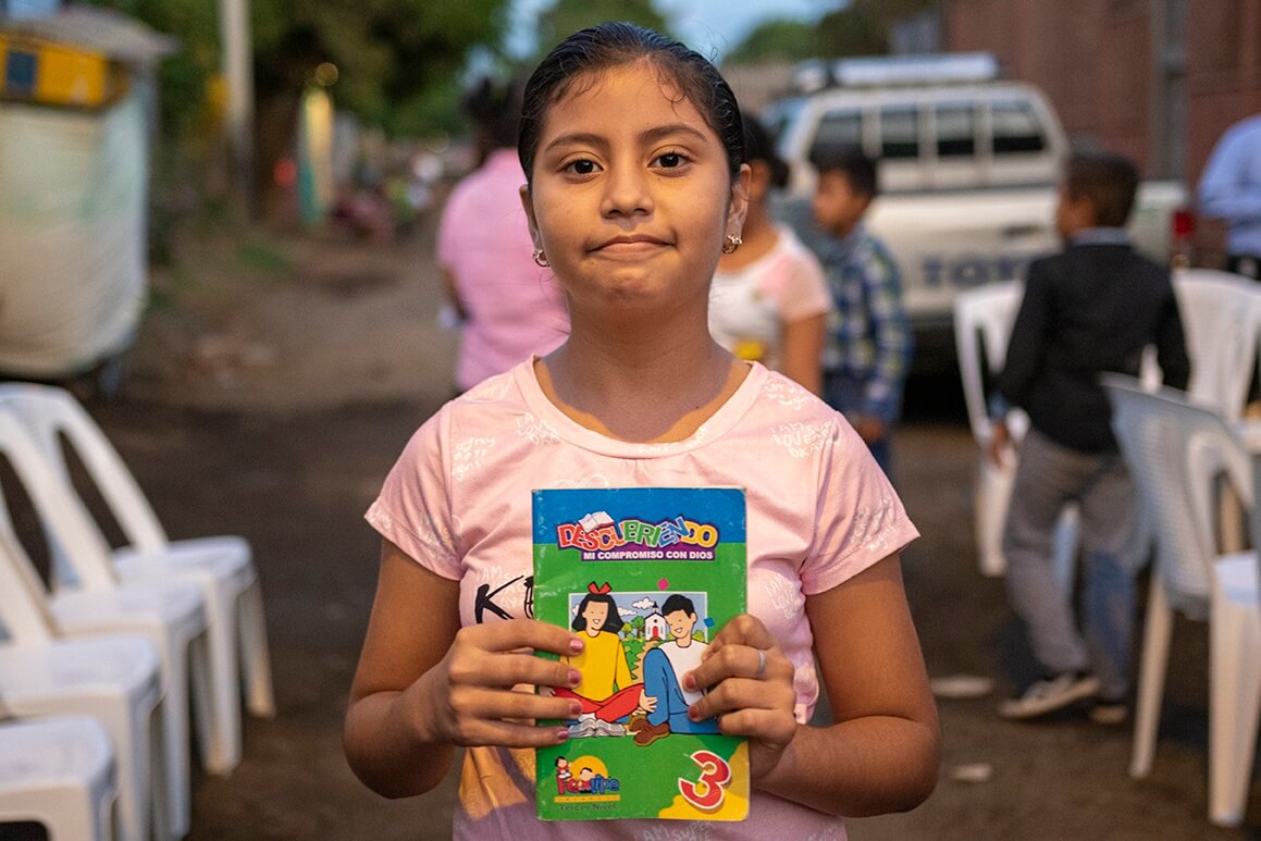 Marcela holding a book