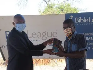 Blessing receiving a book