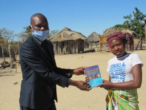 Taderera receiving a book