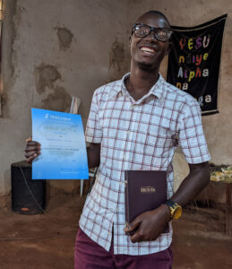 Vianney With His Certificate And Bible