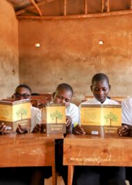 Bur Pp kids holding up Bible League bibles.