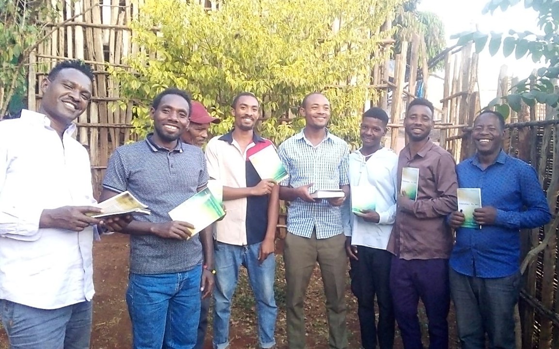 a group of men praying together_Bible League. 