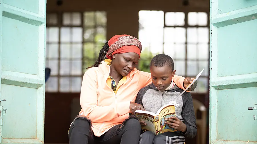 Brian (right) Reading His Bible With His Mother